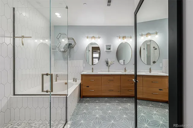 a bathroom with a double vanity sink and a mirror