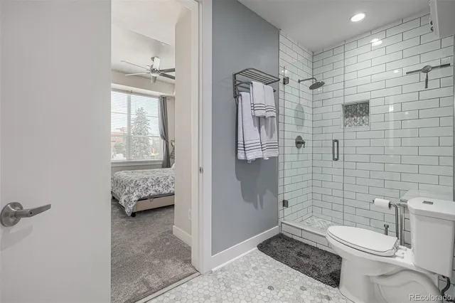 a bathroom with a toilet sink and shower