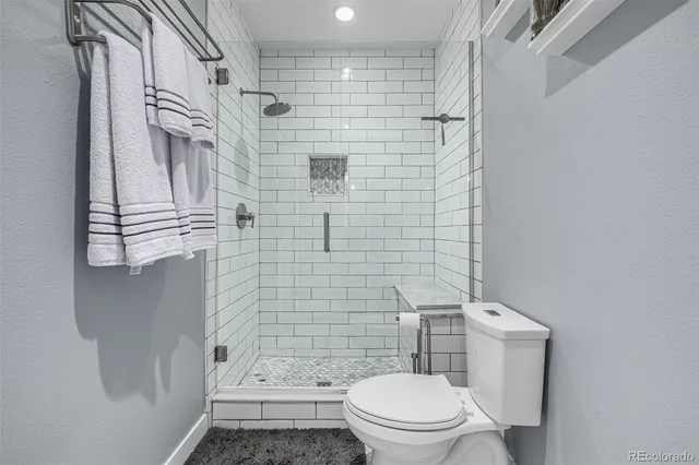 a bathroom with a toilet and shower