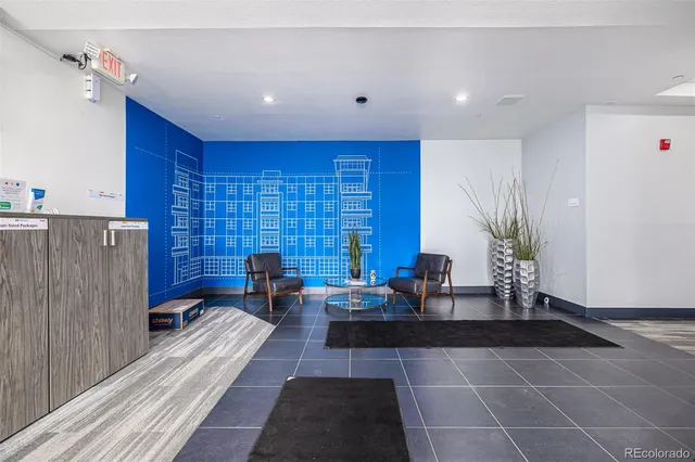 a lobby with furniture and a potted plant