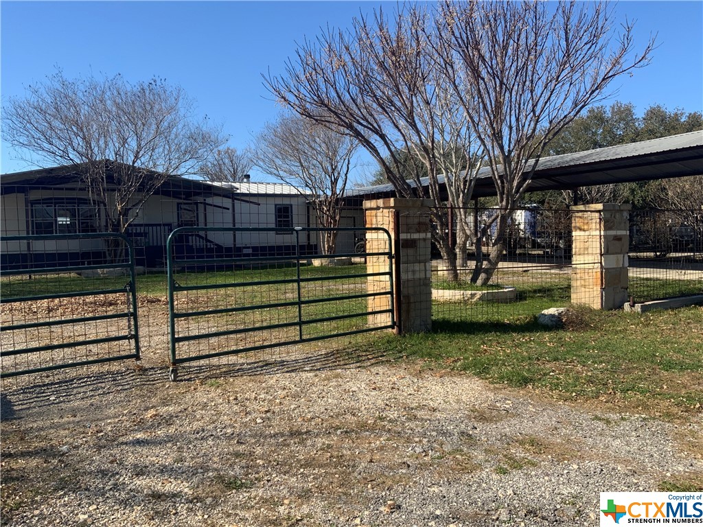 275 Sunset Ridge Maxwell, TX 78656 - Photo 1 of 1 a view of a yard with wooden fence