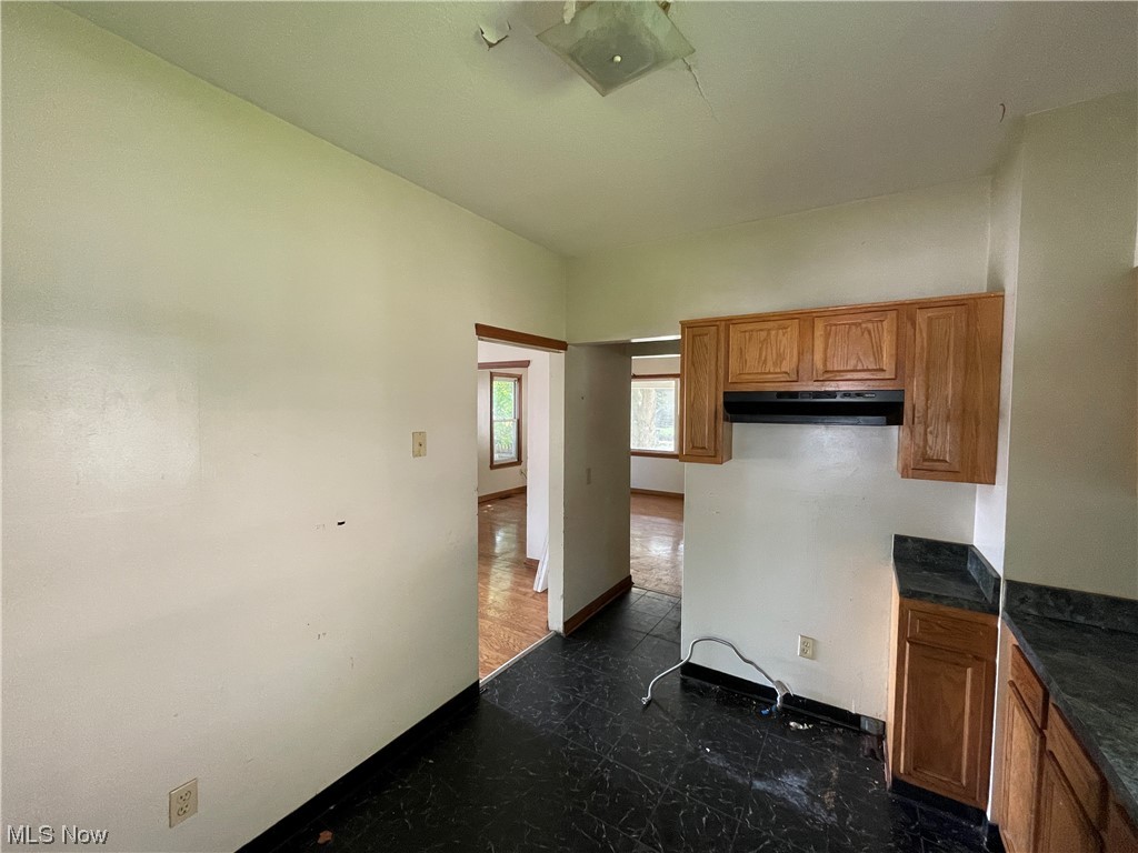 829 Berwin Street Akron, OH 44310 - Photo 3 of 24 Kitchen featuring dark countertops, tile floors, and brown cabinets