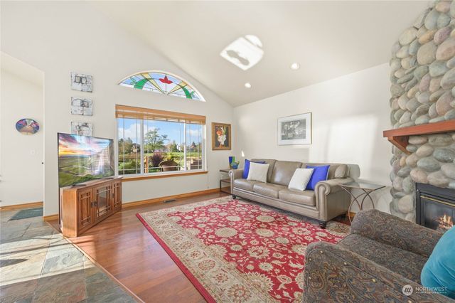 a living room with furniture a rug and a fireplace
