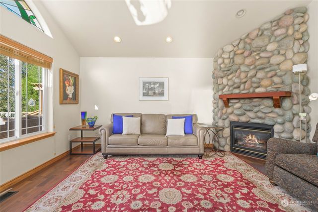 a living room with furniture a rug and a fireplace