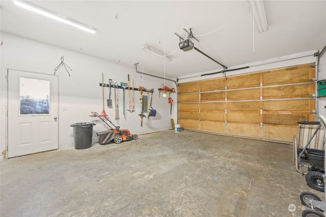 a view of a garage with a flat screen tv and a large window