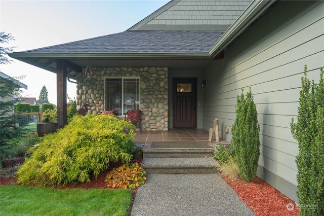 a front view of a house with garden