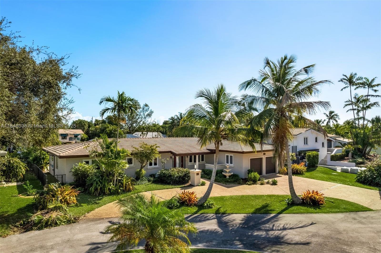 a front view of a house with a yard and outdoor seating