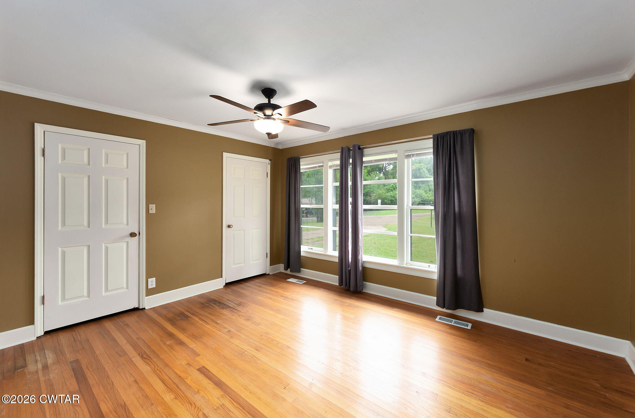 118 Radio Road Jackson, TN 38301 - Photo 13 of 22 a view of an empty room with a window and wooden floor