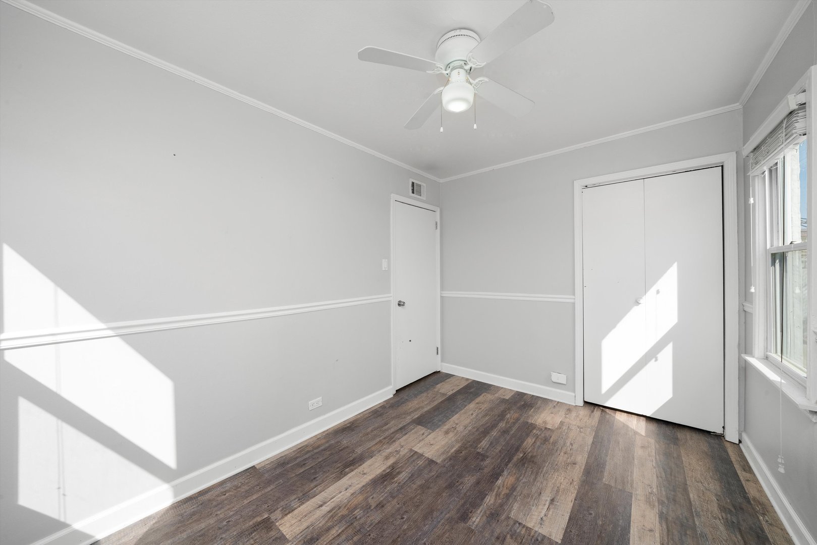 10647 Princess Avenue Chicago Ridge, IL 60415 - Photo 11 of 26 wooden floor in an empty room with a window