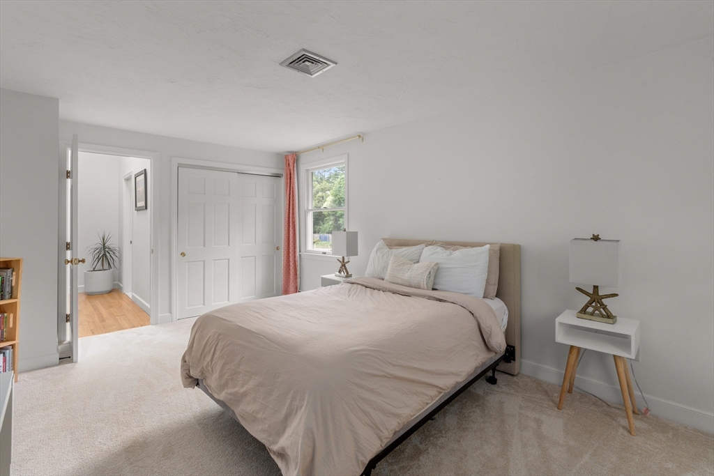 322 Concord Road Wayland, MA 01778 - Photo 21 of 35 a bedroom with a bed and a table