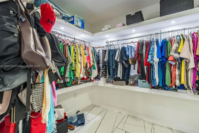 a view of walk in closet with clothes
