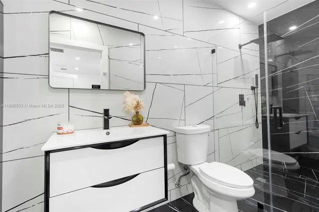 a bathroom with a sink toilet and shower