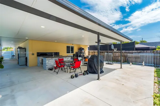 a living room with furniture a rug and gym equipment
