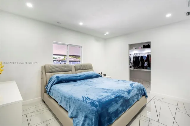 a bedroom with a bed and dresser