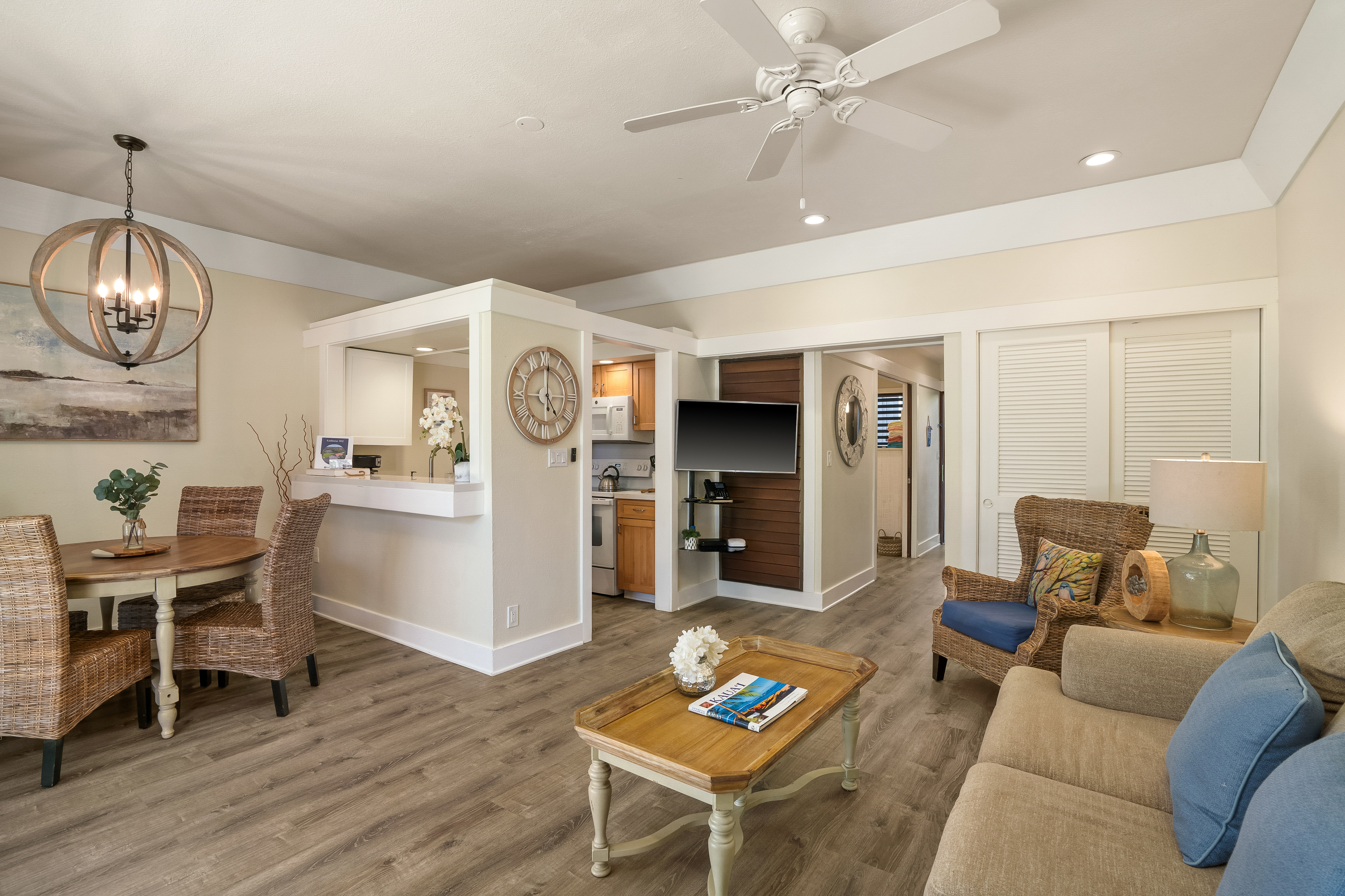 2253 Poipu Road, Unit 402 Koloa, HI 96756 - Photo 4 of 16 a living room with furniture a rug and a chandelier