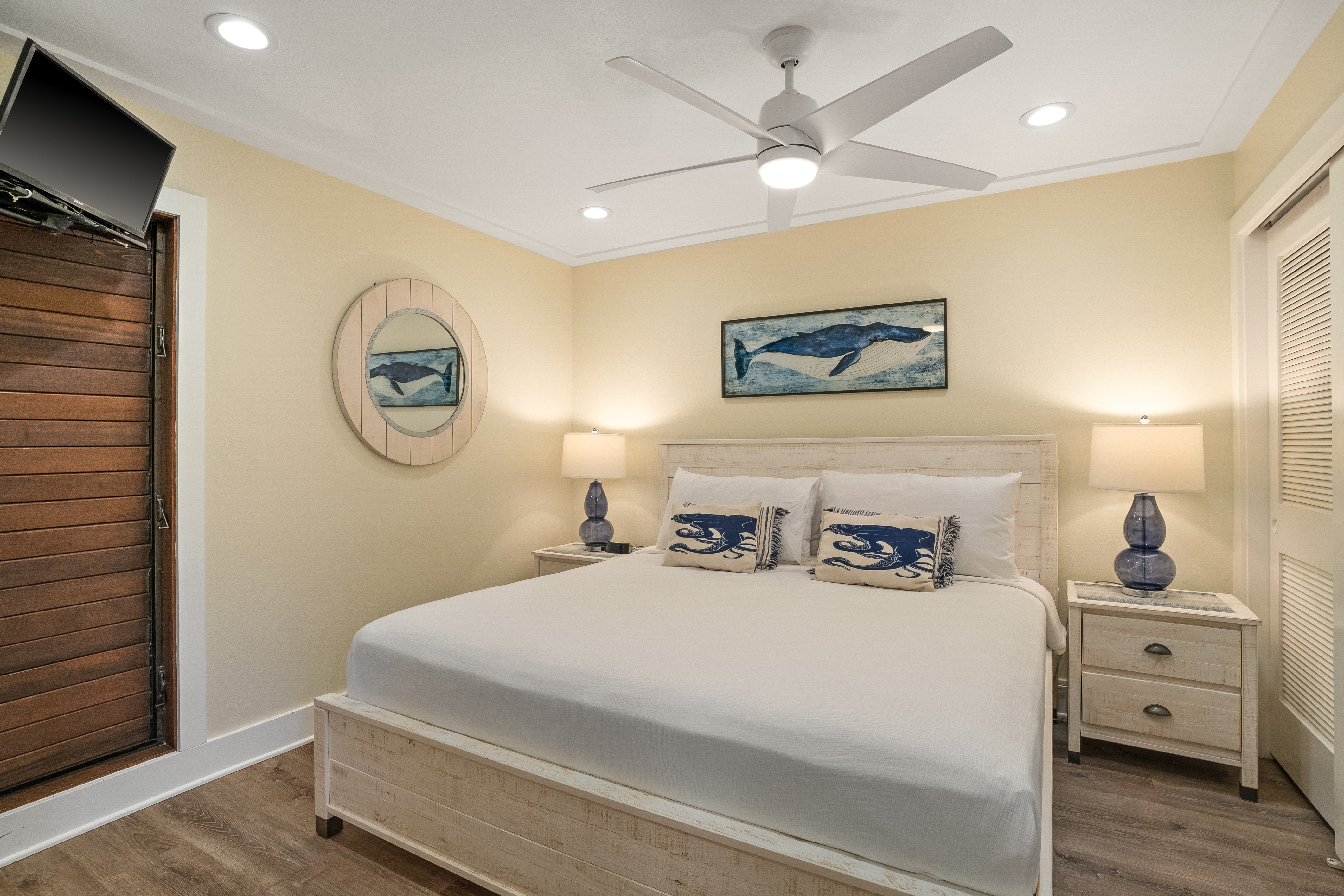 2253 Poipu Road, Unit 402 Koloa, HI 96756 - Photo 9 of 16 a bedroom with a bed and a chandelier