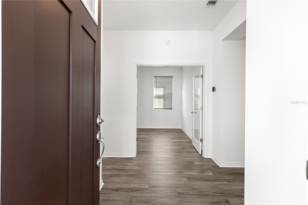 10242 Southwest 99th Lane Ocala, FL 34481 - Photo 11 of 51 a view of a hallway with wooden floor