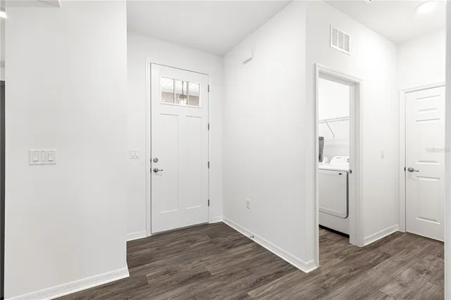 a view of empty room with wooden floor