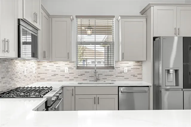 a kitchen with a sink stove and refrigerator