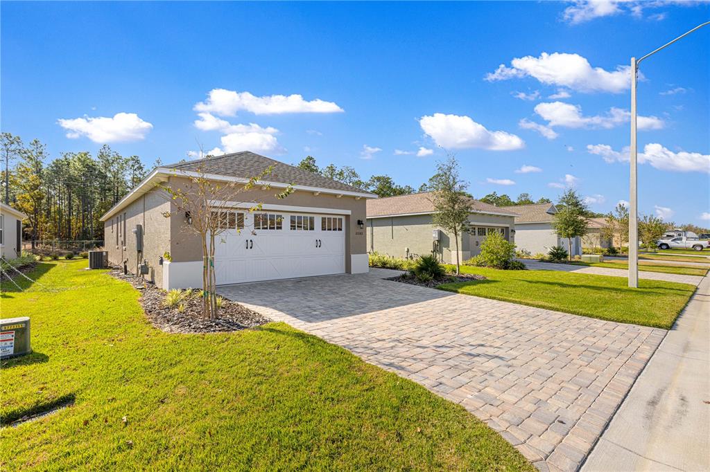 10242 Southwest 99th Lane Ocala, FL 34481 - Photo 2 of 51 a view of a house with a yard