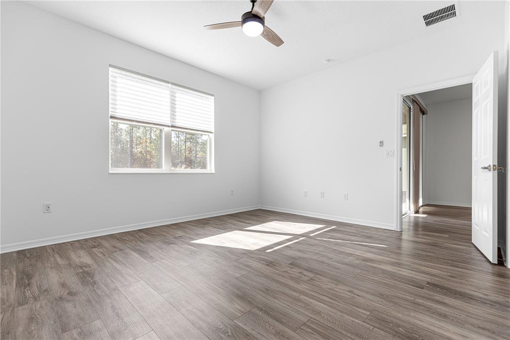 10242 Southwest 99th Lane Ocala, FL 34481 - Photo 25 of 51 a view of an empty room with wooden floor and a window