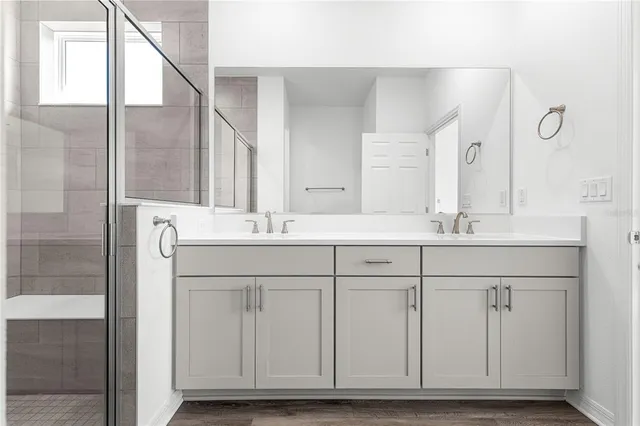 a bathroom with a sink toilet and shower