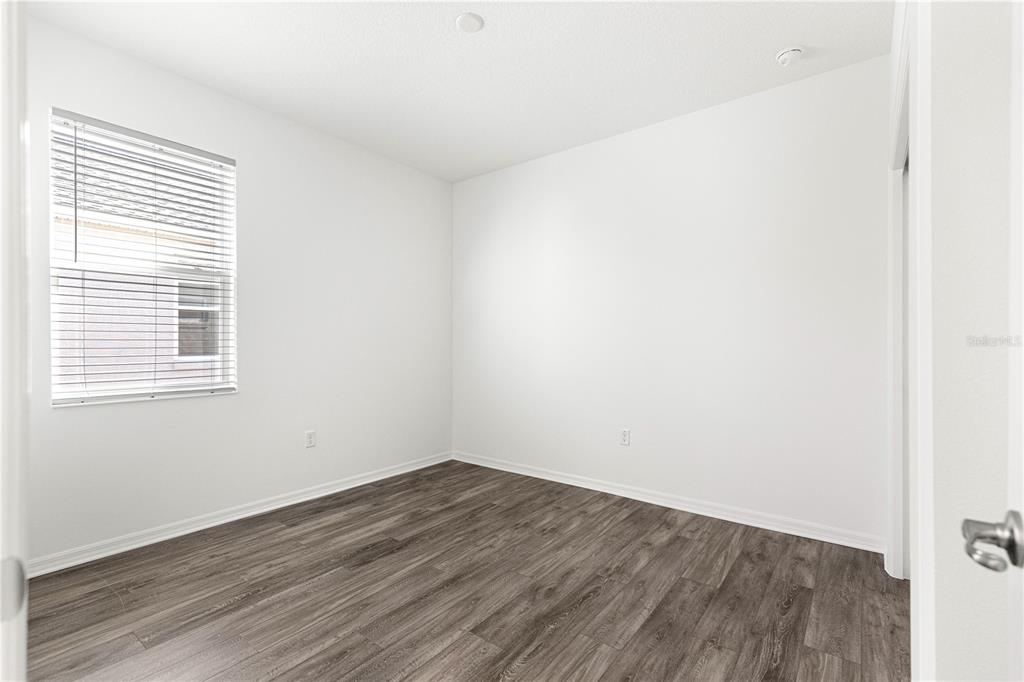 10242 Southwest 99th Lane Ocala, FL 34481 - Photo 32 of 51 a view of a room that has wooden floor and a window