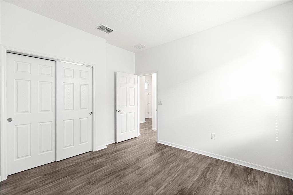 10242 Southwest 99th Lane Ocala, FL 34481 - Photo 33 of 51 a view of an empty room with wooden floor