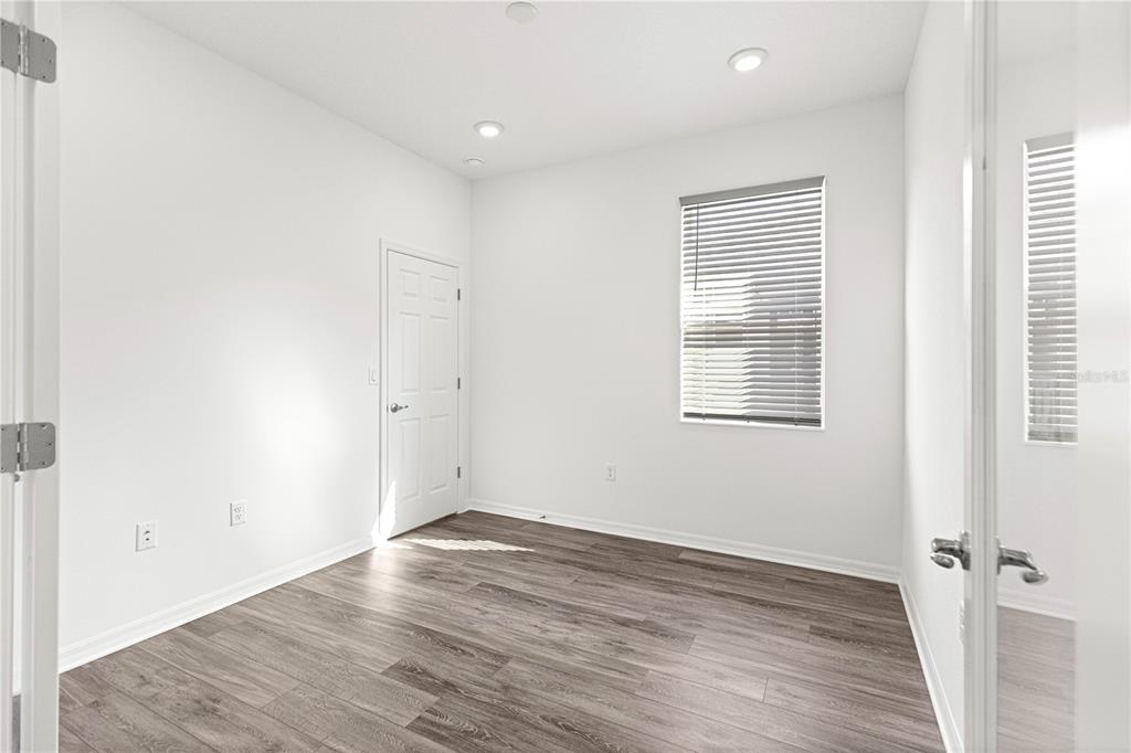 10242 Southwest 99th Lane Ocala, FL 34481 - Photo 36 of 51 an empty room with wooden floor and windows