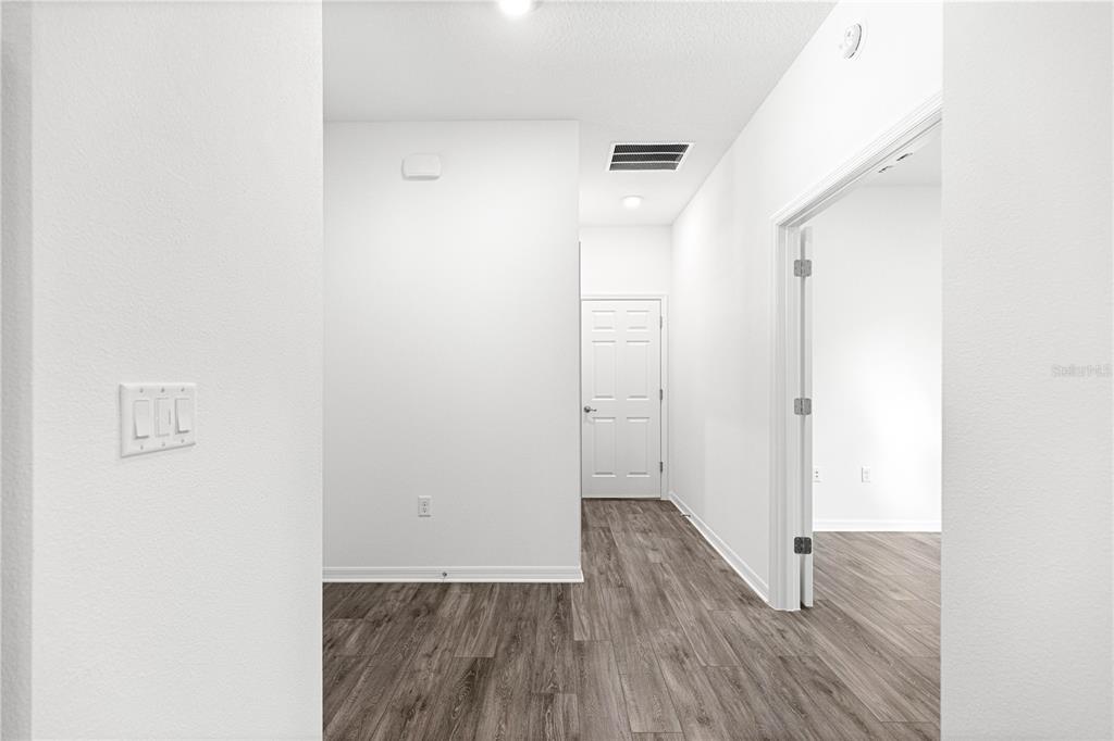 10242 Southwest 99th Lane Ocala, FL 34481 - Photo 40 of 51 a view of a hallway with wooden floor