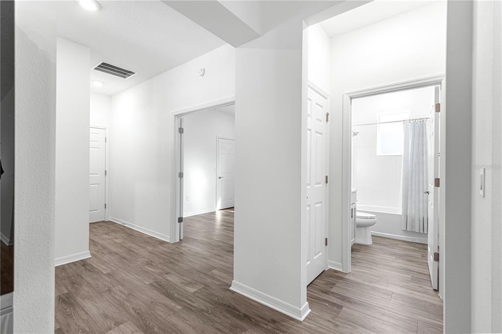 10242 Southwest 99th Lane Ocala, FL 34481 - Photo 43 of 51 a view of a hallway with wooden floor and a bathroom