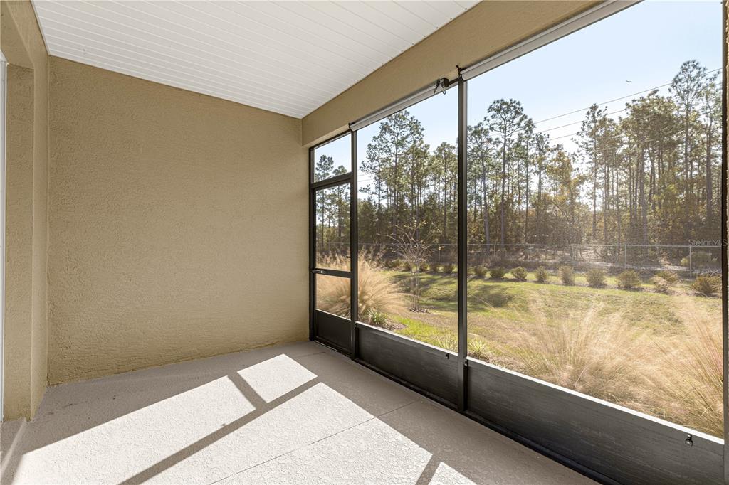 10242 Southwest 99th Lane Ocala, FL 34481 - Photo 45 of 51 a view of a room with wooden floor and windows