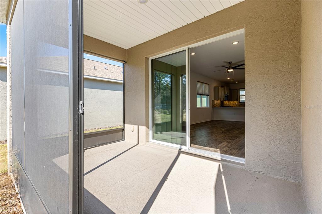 10242 Southwest 99th Lane Ocala, FL 34481 - Photo 46 of 51 a bedroom with a bed and a glass door shower