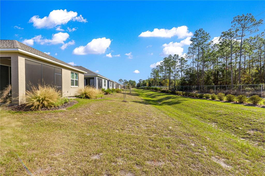 10242 Southwest 99th Lane Ocala, FL 34481 - Photo 47 of 51 a view of a house with a big yard