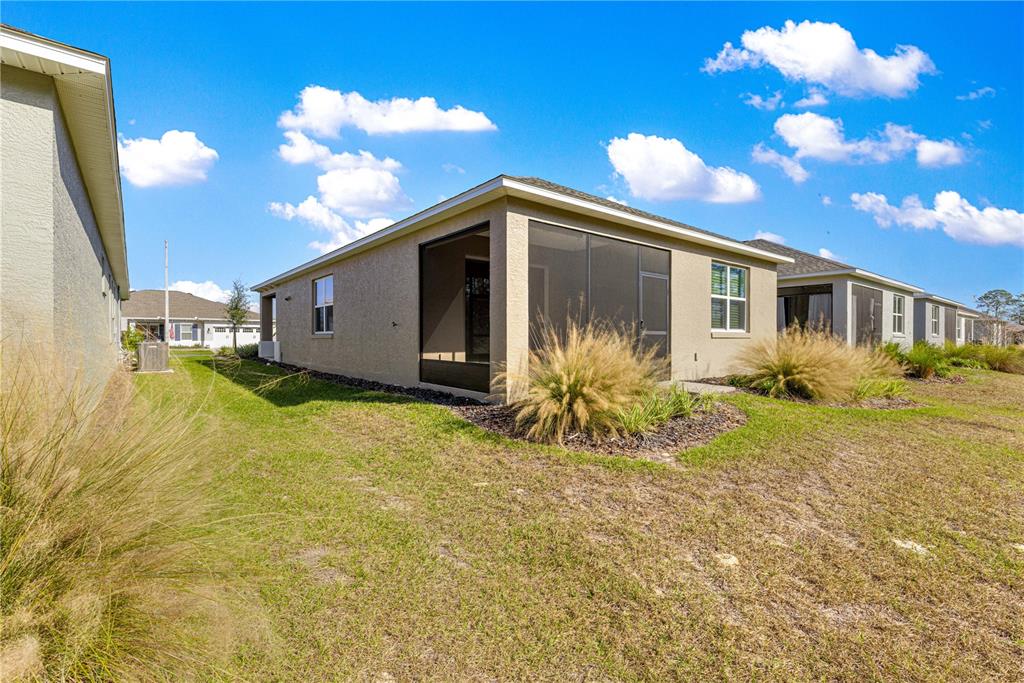 10242 Southwest 99th Lane Ocala, FL 34481 - Photo 48 of 51 a front view of a house with garden