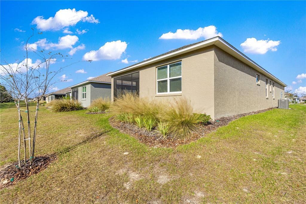 10242 Southwest 99th Lane Ocala, FL 34481 - Photo 49 of 51 a view of a house with a yard