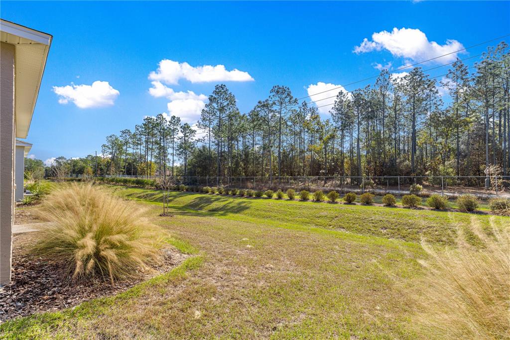 10242 Southwest 99th Lane Ocala, FL 34481 - Photo 50 of 51 a view of a swimming pool with an outdoor space and seating area