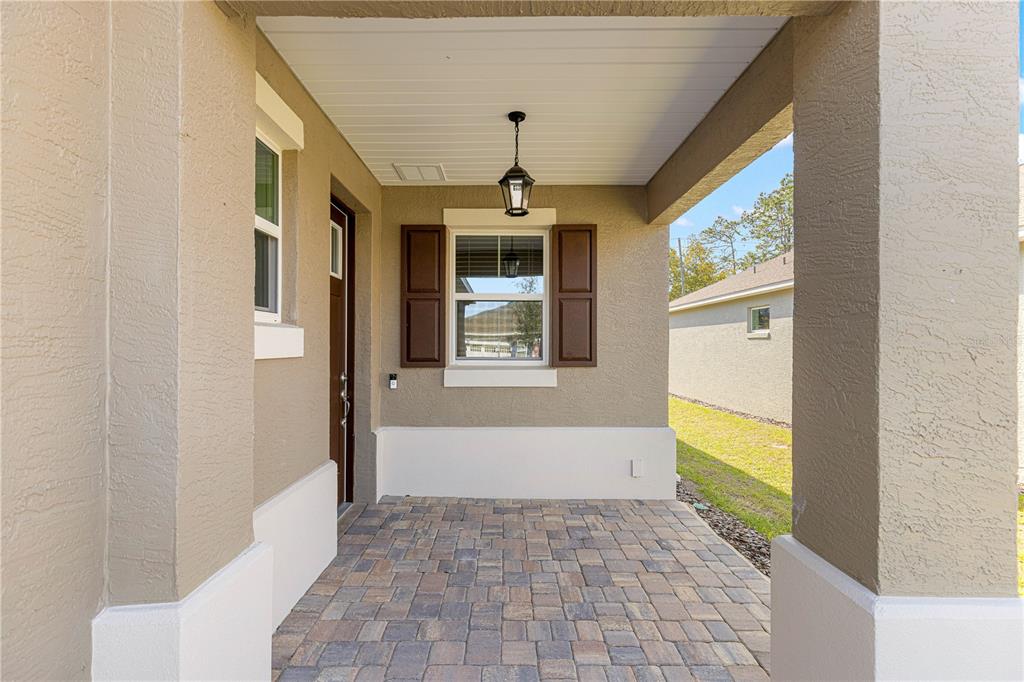 10242 Southwest 99th Lane Ocala, FL 34481 - Photo 8 of 51 a front view of a house with a large window