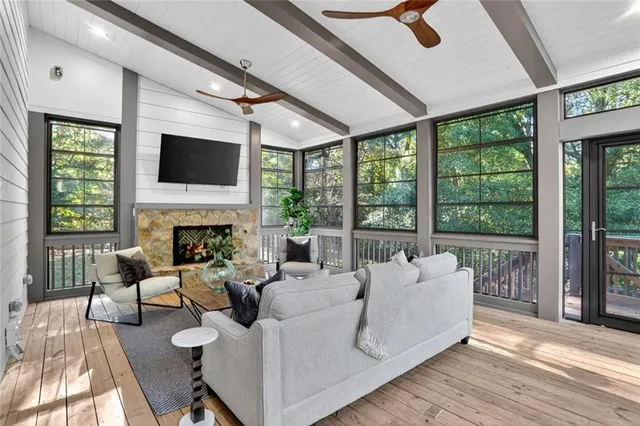 a living room with furniture a fireplace and a flat screen tv