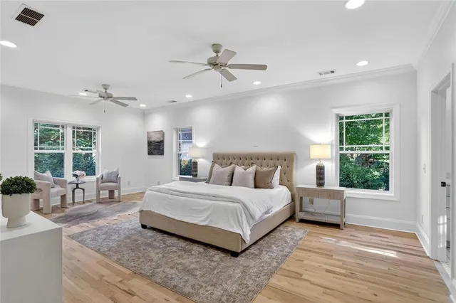 a spacious bedroom with a large bed and windows