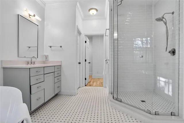 a bathroom with a shower sink and mirror