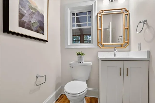 a bathroom with a toilet a sink and mirror
