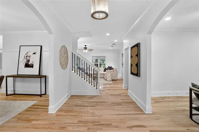 a view of a hallway with wooden floor and furniture