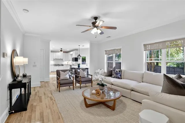 a living room with furniture a rug and a window