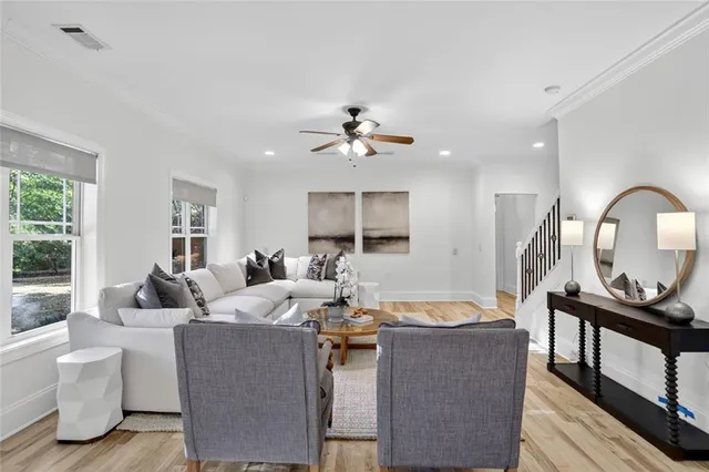 a living room with furniture a fireplace and a chandelier