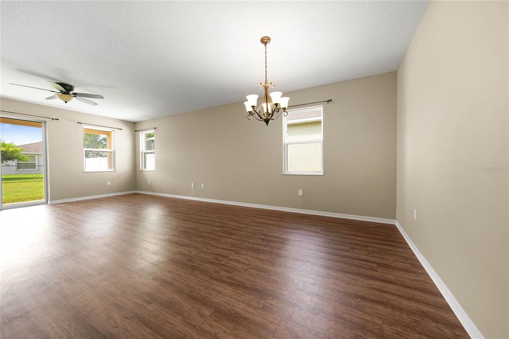 10147 Winding River Road Punta Gorda, FL 33950 - Photo 11 of 33 an empty room with wooden floor and windows
