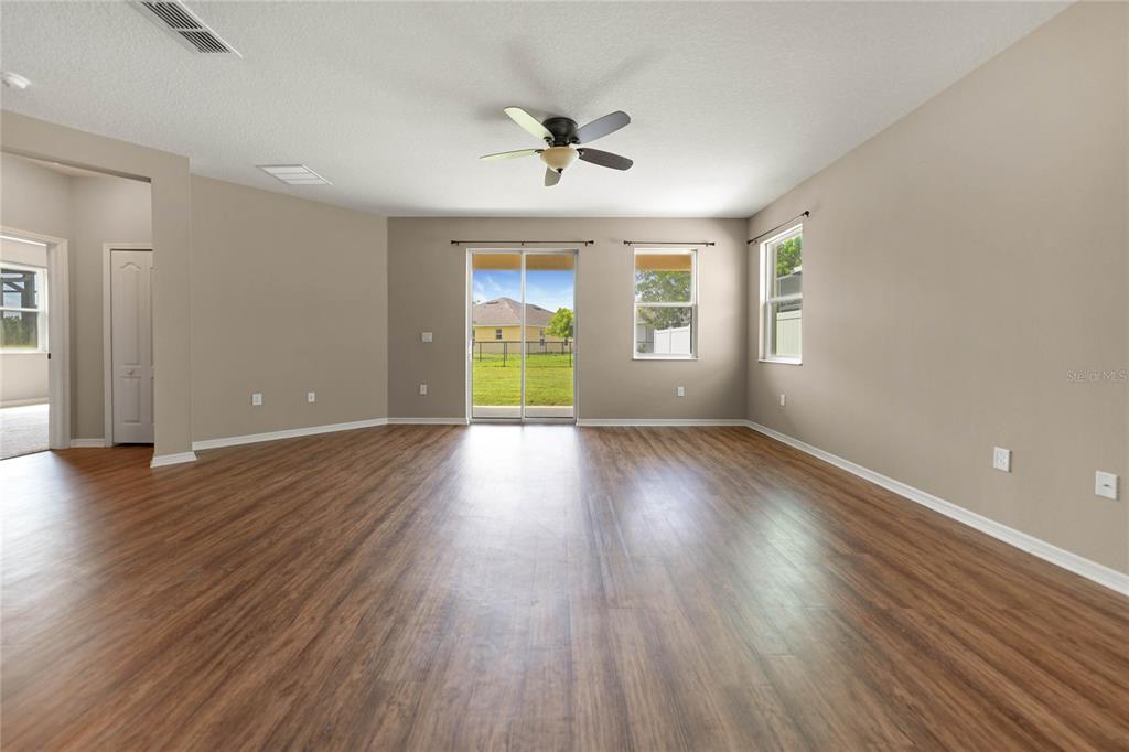 10147 Winding River Road Punta Gorda, FL 33950 - Photo 12 of 33 a view of an empty room with wooden floor and a window