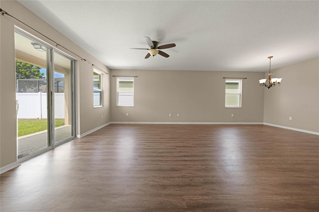 10147 Winding River Road Punta Gorda, FL 33950 - Photo 13 of 33 an empty room with wooden floor and windows