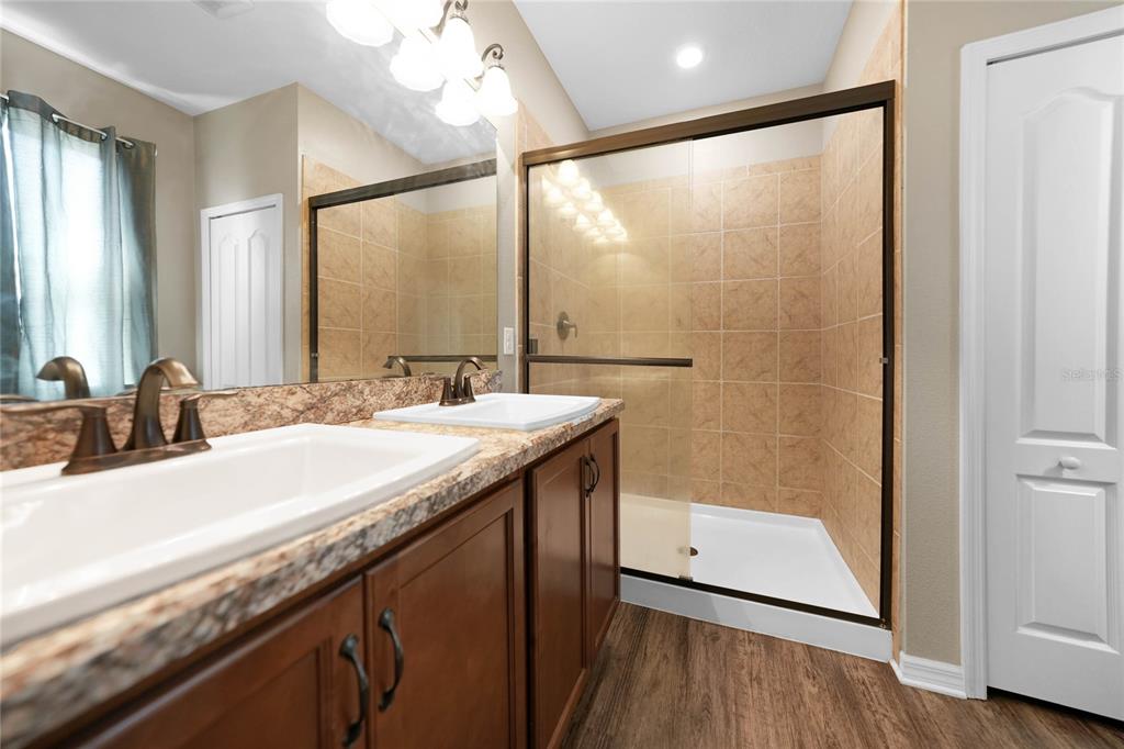 10147 Winding River Road Punta Gorda, FL 33950 - Photo 18 of 33 a bathroom with a granite countertop sink a mirror and a shower