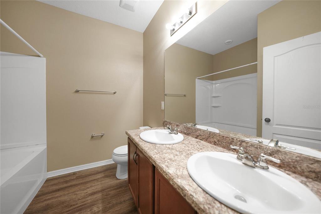 10147 Winding River Road Punta Gorda, FL 33950 - Photo 22 of 33 a bathroom with a granite countertop sink toilet and shower